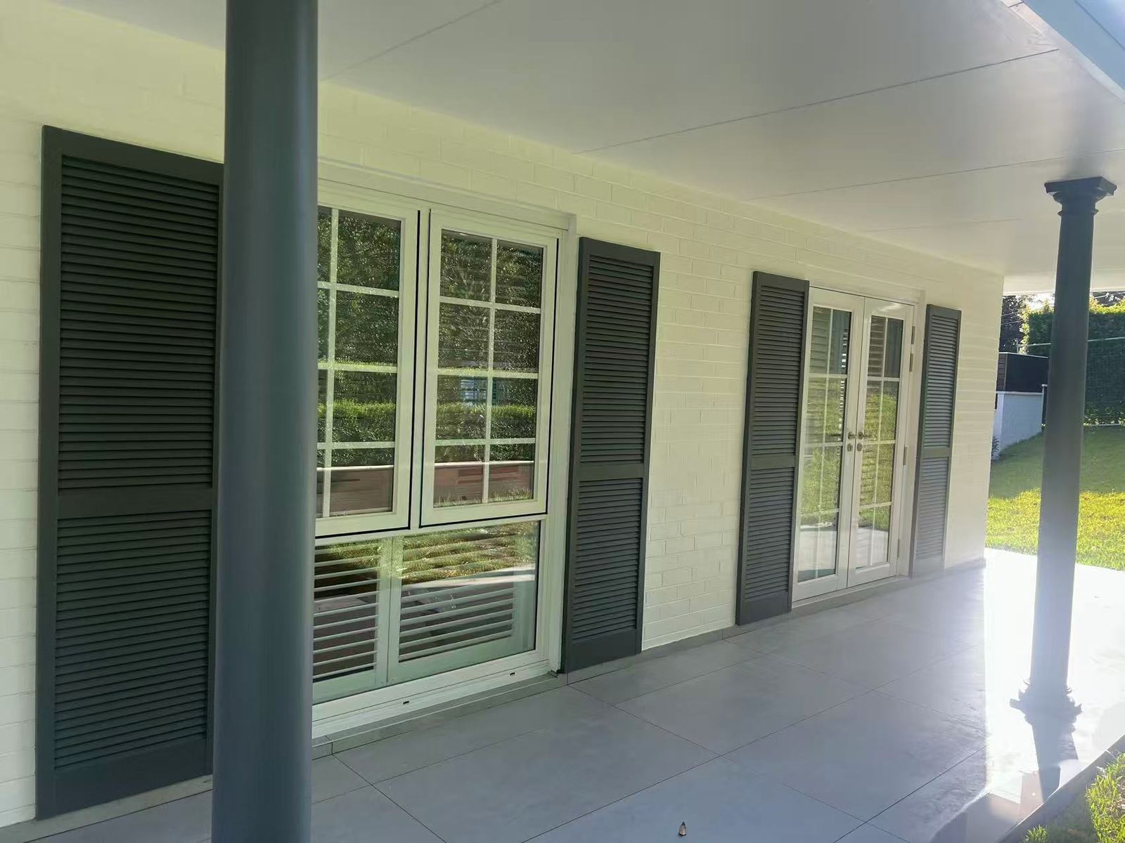 Colonial-style home with white grid-bar windows and French doors